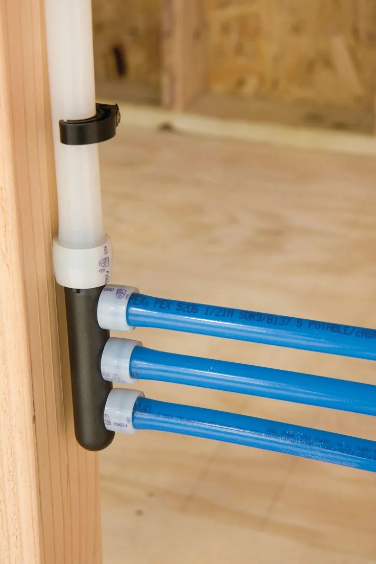 Blue PEX lines leaving a manifold fastened to a wall stud – Repiping a Condo or Townhome for Aliso Viejo, CA homes